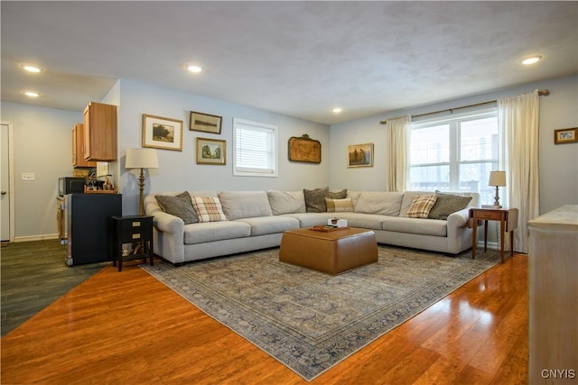 living room with recessed lighting, dark wood-style floors, and baseboards