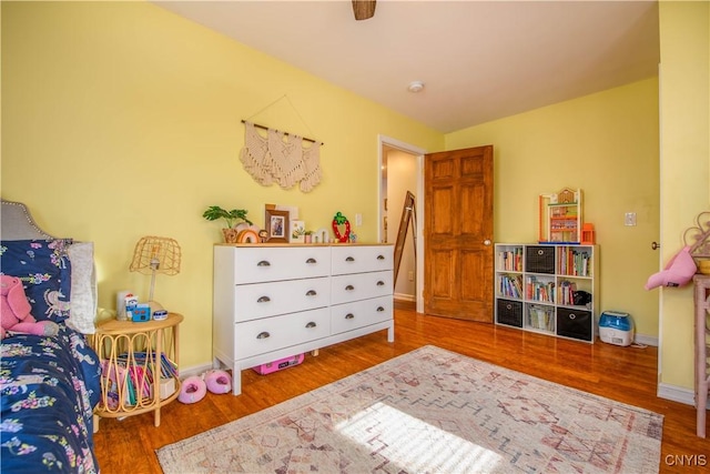 bedroom with baseboards and wood finished floors