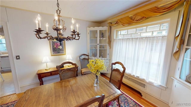 dining room featuring an inviting chandelier and wood finished floors