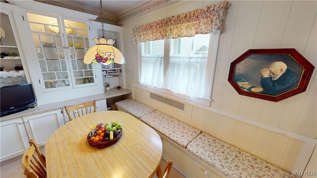 dining space featuring crown molding