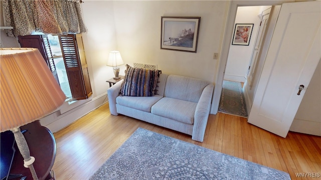 living area with baseboards and hardwood / wood-style floors