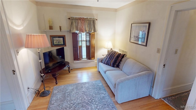 living area with wood finished floors and baseboards