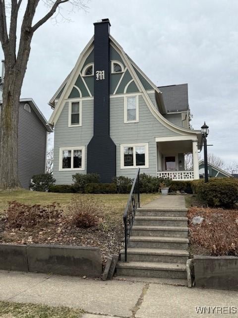 view of front of property featuring a porch and a chimney