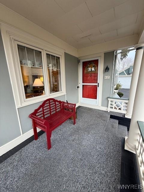 entrance to property with stucco siding and a porch