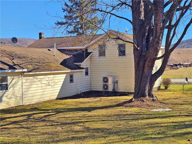 rear view of house featuring a yard