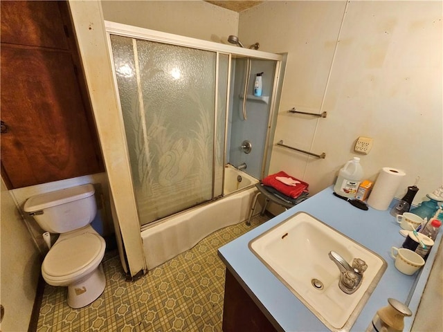 bathroom with enclosed tub / shower combo, toilet, and vanity