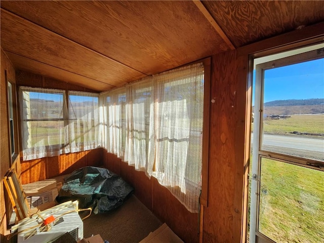 sunroom / solarium featuring plenty of natural light, wooden ceiling, and vaulted ceiling