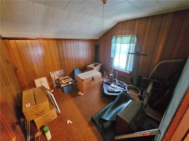 bonus room featuring wood walls, lofted ceiling, and carpet floors