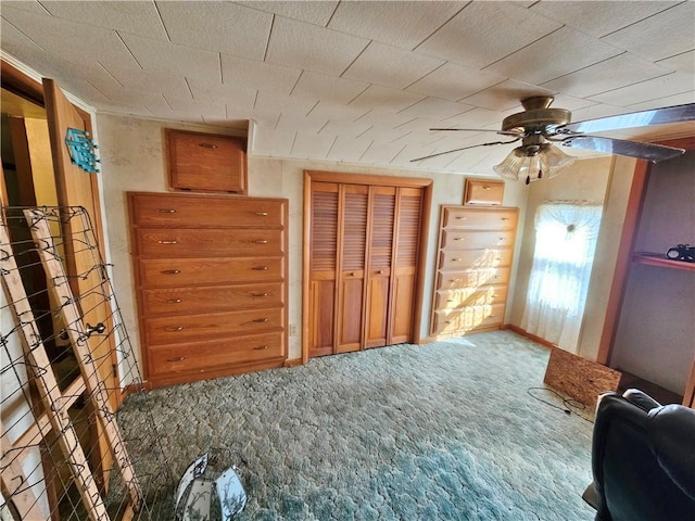 unfurnished bedroom with a closet, baseboards, carpet, and ceiling fan