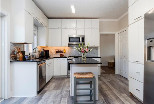 kitchen with a sink, appliances with stainless steel finishes, and white cabinets