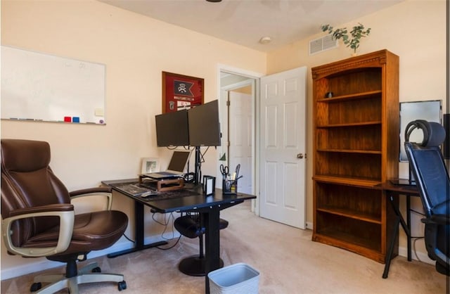 home office with baseboards, visible vents, and light carpet