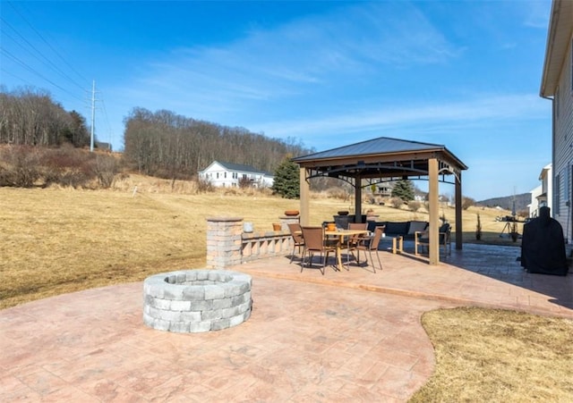 view of patio / terrace with a gazebo and a fire pit