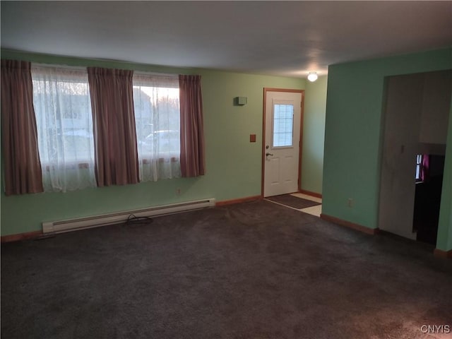 unfurnished living room with baseboards, carpet floors, and a baseboard radiator