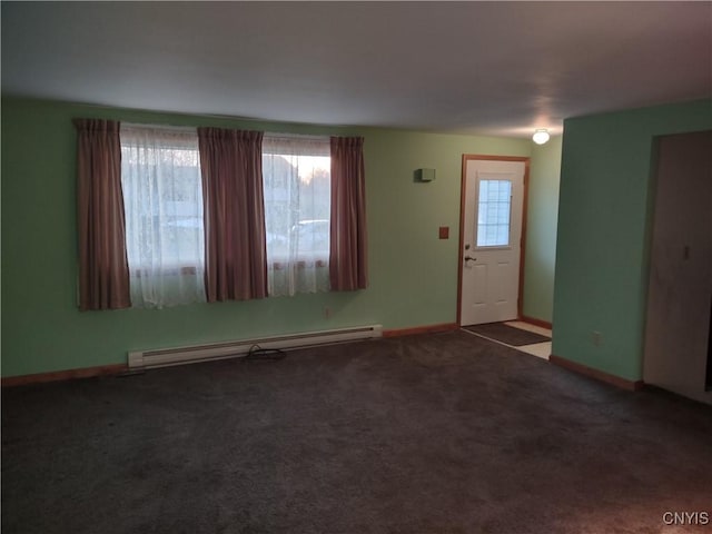 interior space featuring baseboards, plenty of natural light, baseboard heating, and carpet flooring