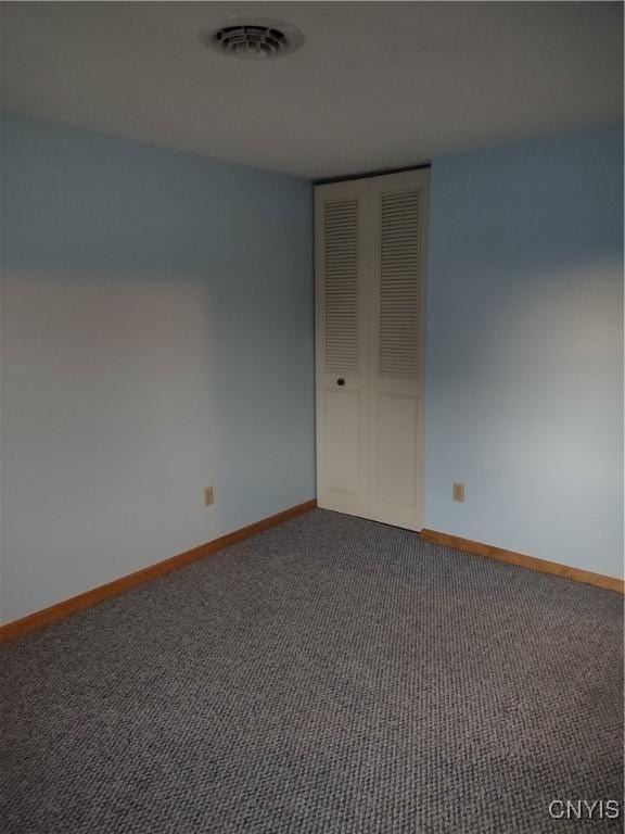 unfurnished room featuring carpet flooring, baseboards, and visible vents