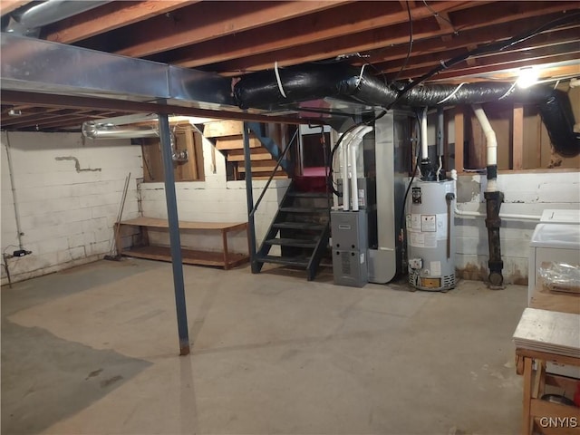 unfinished basement featuring heating unit, gas water heater, stairway, and washer / clothes dryer