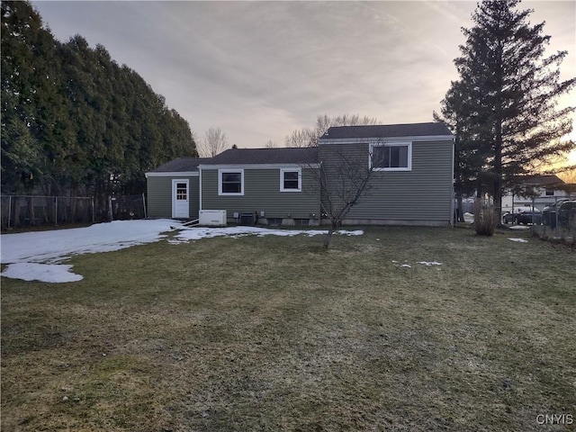 view of front of home featuring a lawn and fence