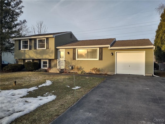 tri-level home with an attached garage and driveway