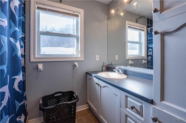 full bath featuring vanity, tile patterned floors, a shower with curtain, and baseboards