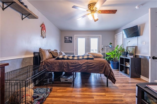 bedroom with french doors, ceiling fan, and wood finished floors