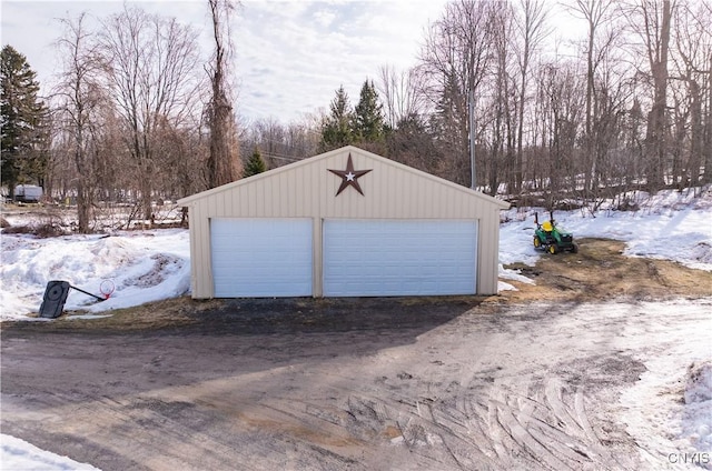 snow covered garage with a garage