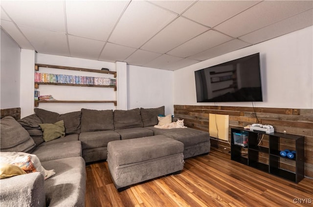 living area with wood finished floors and a drop ceiling