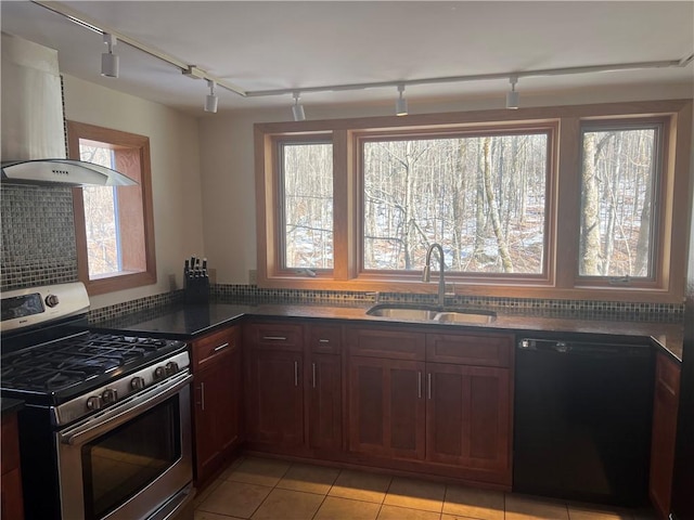 kitchen featuring a healthy amount of sunlight, stainless steel range with gas cooktop, a sink, dishwasher, and wall chimney range hood