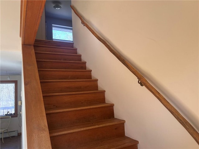 stairs featuring baseboard heating