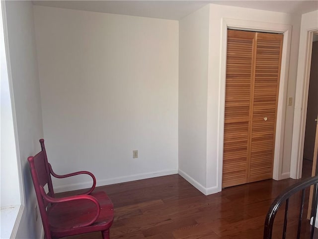 sitting room featuring baseboards and dark wood-style flooring