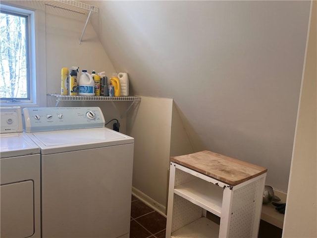 laundry room with laundry area, dark tile patterned floors, and washing machine and clothes dryer