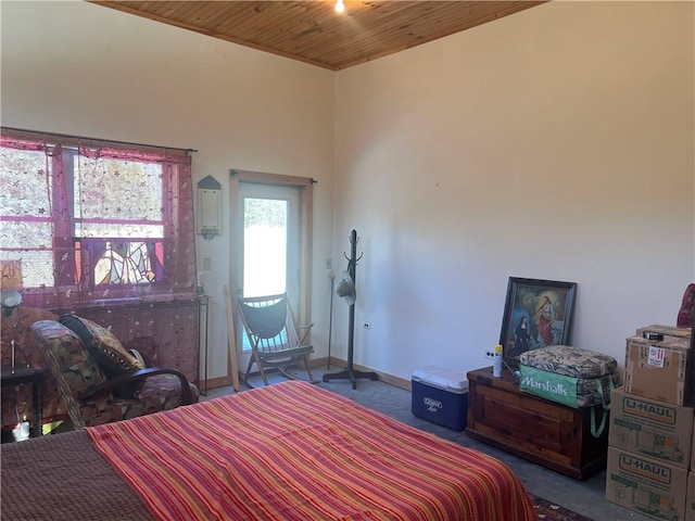 bedroom featuring carpet flooring, wooden ceiling, and baseboards