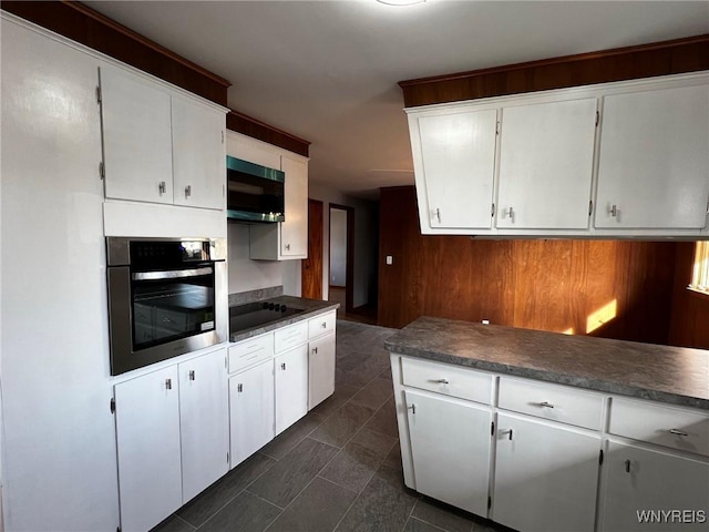 kitchen featuring white cabinetry, black electric stovetop, and oven