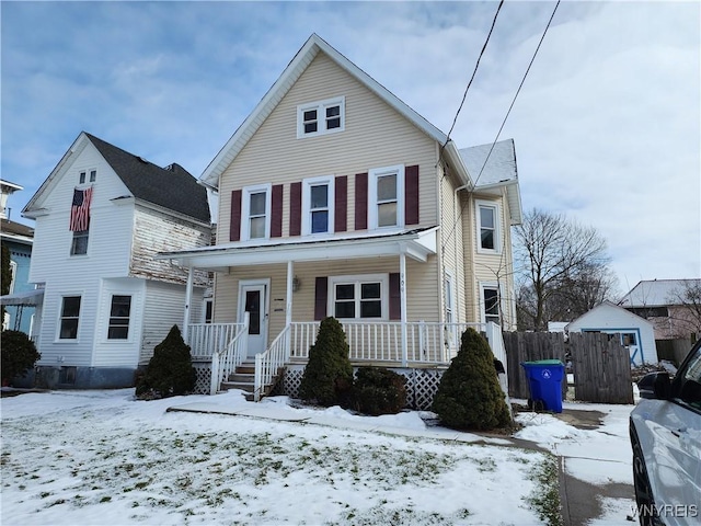 view of front of house with covered porch and fence