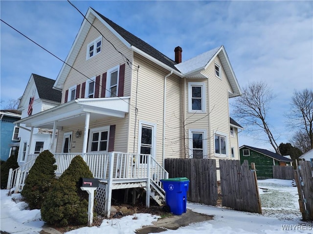 view of front of house featuring a porch and fence