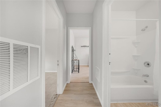 full bathroom featuring tub / shower combination, visible vents, baseboards, and wood finished floors