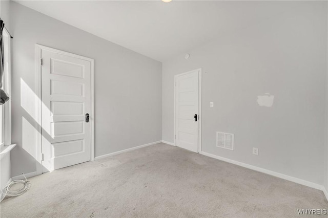 empty room with visible vents, carpet floors, and baseboards