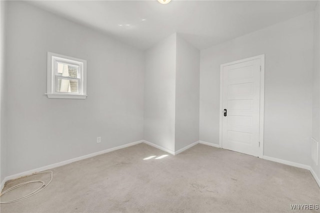 unfurnished room with baseboards and carpet floors