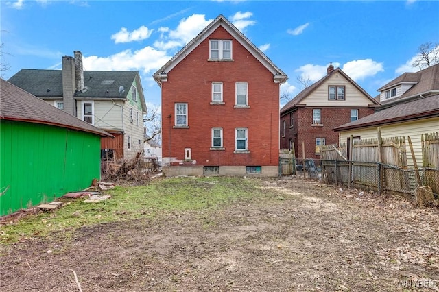 back of property featuring fence