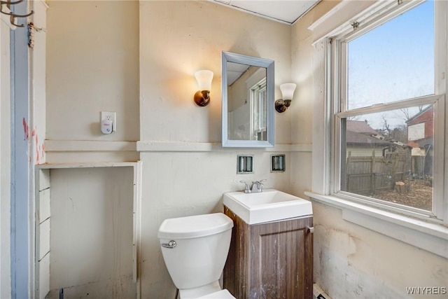 half bath featuring toilet and vanity