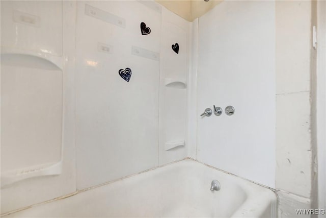 bathroom featuring a washtub and walk in shower