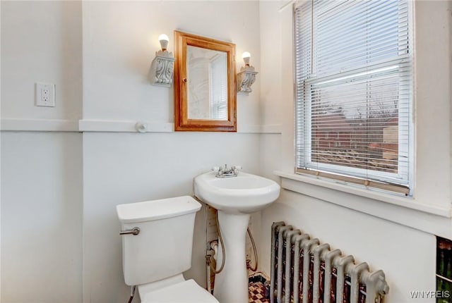 bathroom featuring radiator and toilet