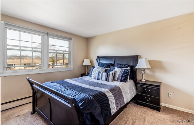 bedroom featuring a baseboard heating unit, carpet, and baseboards