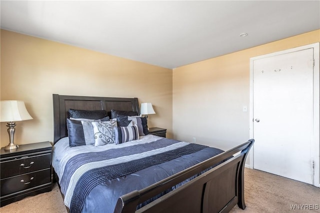 bedroom featuring light carpet