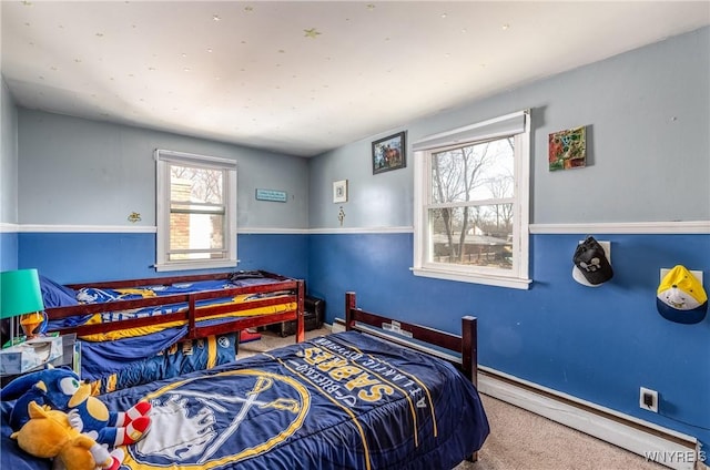 bedroom with carpet floors, baseboards, and a baseboard radiator