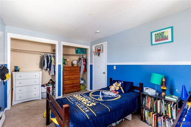 carpeted bedroom with multiple closets