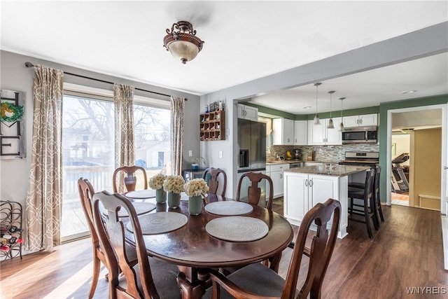 dining area with dark wood finished floors