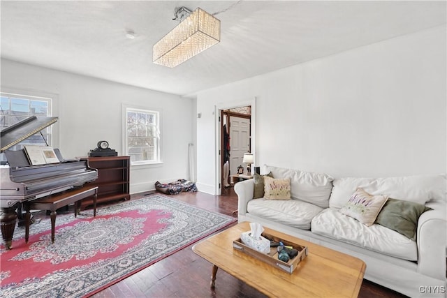 living room with a wealth of natural light, baseboards, and wood finished floors