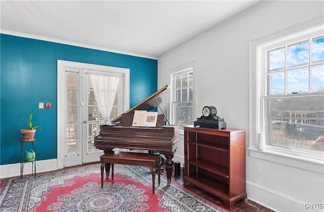 sitting room with baseboards and ornamental molding