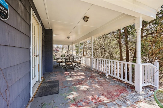 view of patio with a porch and outdoor dining space