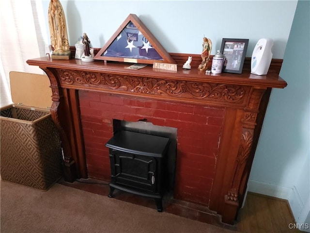 interior details with a wood stove and carpet floors